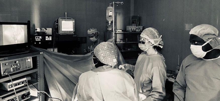 doctors reviewing magnified image during surgery