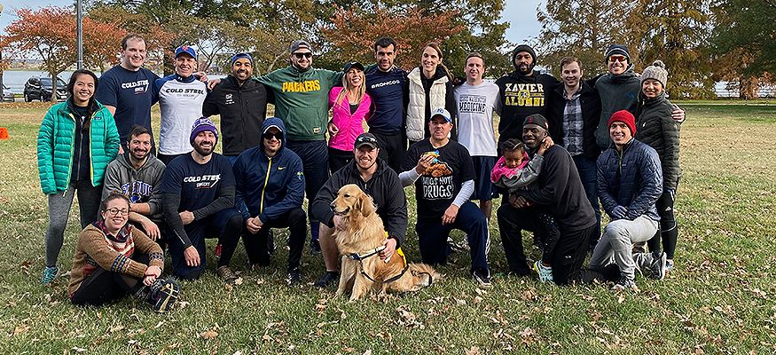Faculty and staff outside with a golden retriever